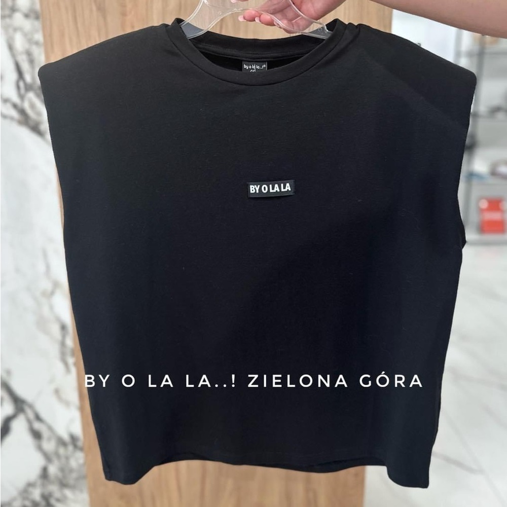 Very stylish top with shoulder pads size L